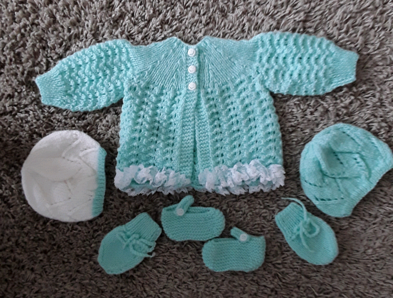 white knitted baby outfit